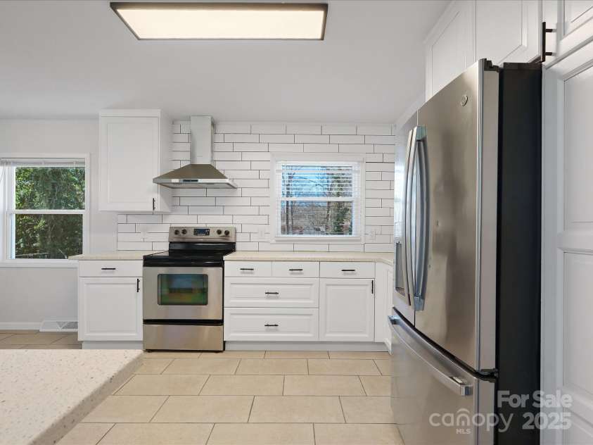 724 Merridale Drive, Charlotte, NC 28214.  MLS# CAR4228503, YatesRealty ID 8170. Open concept kitchen w/ tile floors & custom backsplash