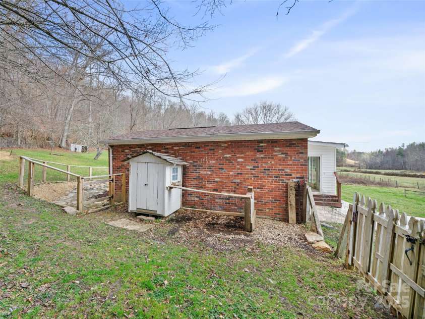 1040 Prices Creek Road, Burnsville, NC 28714.  MLS# CAR4230576, YatesRealty ID 8192. Chicken Coop leading to fenced in back yard
