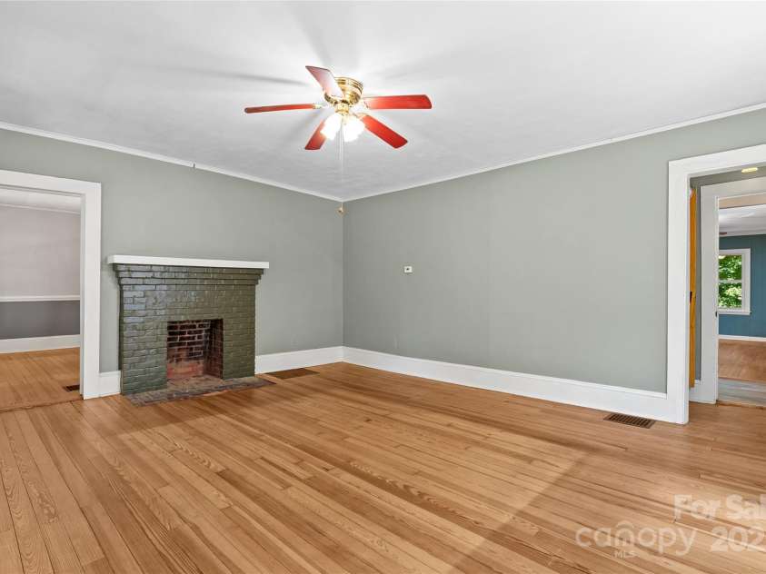 80 Laurel Avenue, Tryon, NC 28782.  MLS# CAR4299418, YatesRealty ID 820. Another view of living room, the door to the left leads to a dining room that has also served as a bedroom recently.