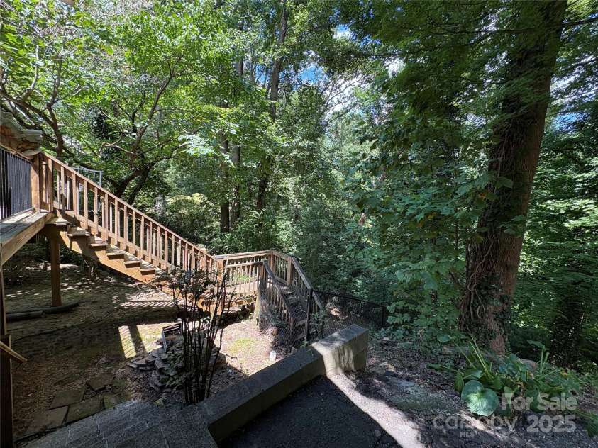 80 Laurel Avenue, Tryon, NC 28782.  MLS# CAR4299418, YatesRealty ID 820. Back deck with steps leading to a fenced pet yard.