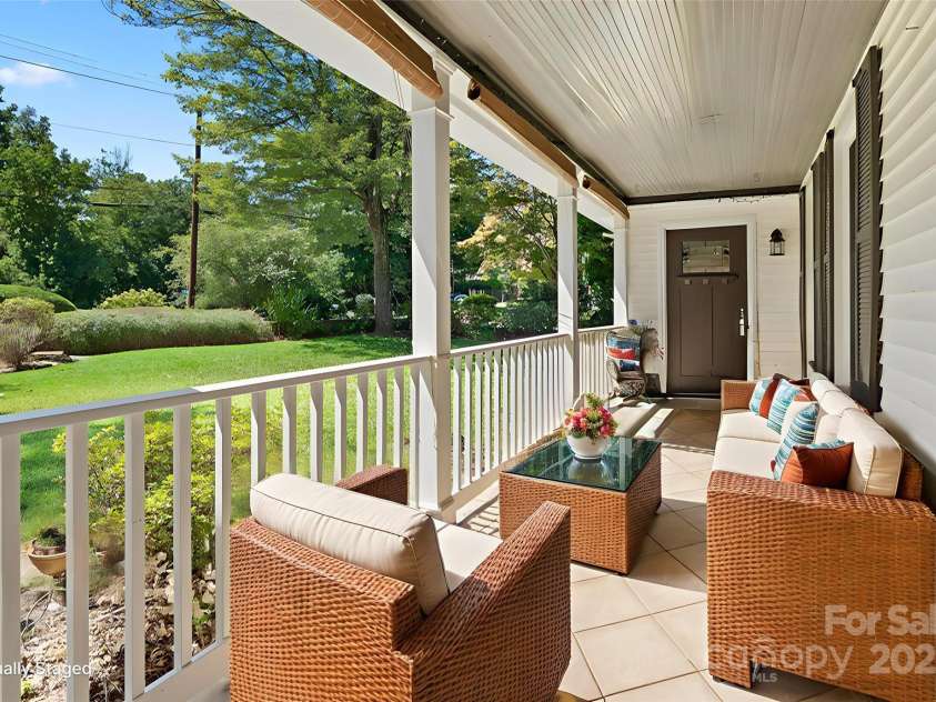 80 Laurel Avenue, Tryon, NC 28782.  MLS# CAR4299418, YatesRealty ID 820. Front porch, door is the separate entrance to a studio apartment.