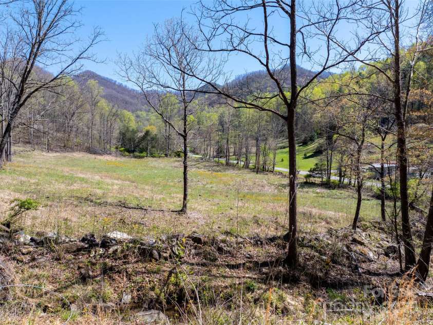 318 Brown Mountain Drive, Cullowhee, NC 28723.  MLS# CAR4235887, YatesRealty ID 8200. 7+/- acre pasture along John's Creek & Road. Complete with Horse Shed & Hay Storage Shed