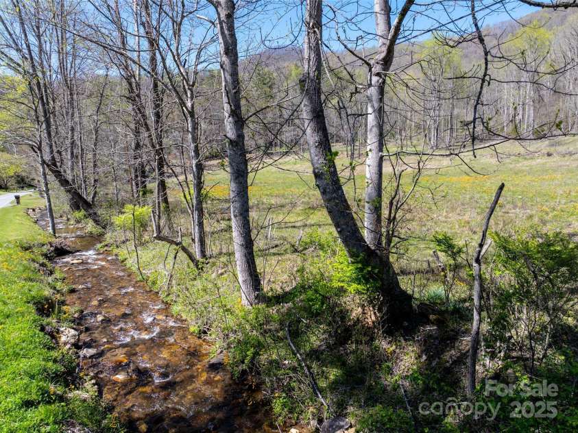 318 Brown Mountain Drive, Cullowhee, NC 28723.  MLS# CAR4235887, YatesRealty ID 8200. 7+/- acre pasture along John's Creek & Road. Complete with Horse Shed & Hay Storage Shed