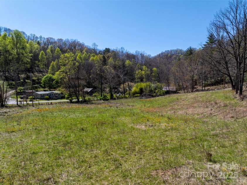 318 Brown Mountain Drive, Cullowhee, NC 28723.  MLS# CAR4235887, YatesRealty ID 8200. 7+/- acre pasture along John's Creek & Road. Complete with Horse Shed & Hay Storage Shed
