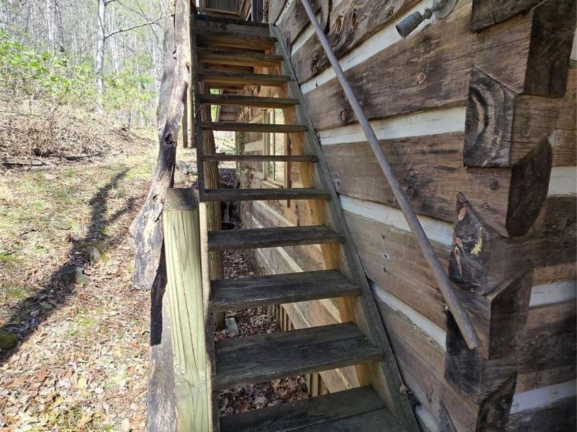 318 Brown Mountain Drive, Cullowhee, NC 28723.  MLS# CAR4235887, YatesRealty ID 8200. Outside stair case to 2nd BR, half bathn & Laundry