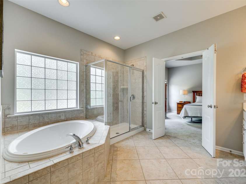 349 Miners Cove Way, Fort Mill, SC 29708.  MLS# CAR4248883, YatesRealty ID 8213. A large, deep soaking tub invites relaxation and rejuvenation.