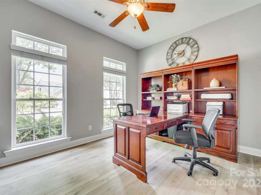 349 Miners Cove Way, Fort Mill, SC 29708.  MLS# CAR4248883, YatesRealty ID 8213. The home office is completely separate from the main living areas, offering a peaceful environment ideal for focused work or study. Access is provided via attractive French doors, which add a touch of elegance and allow