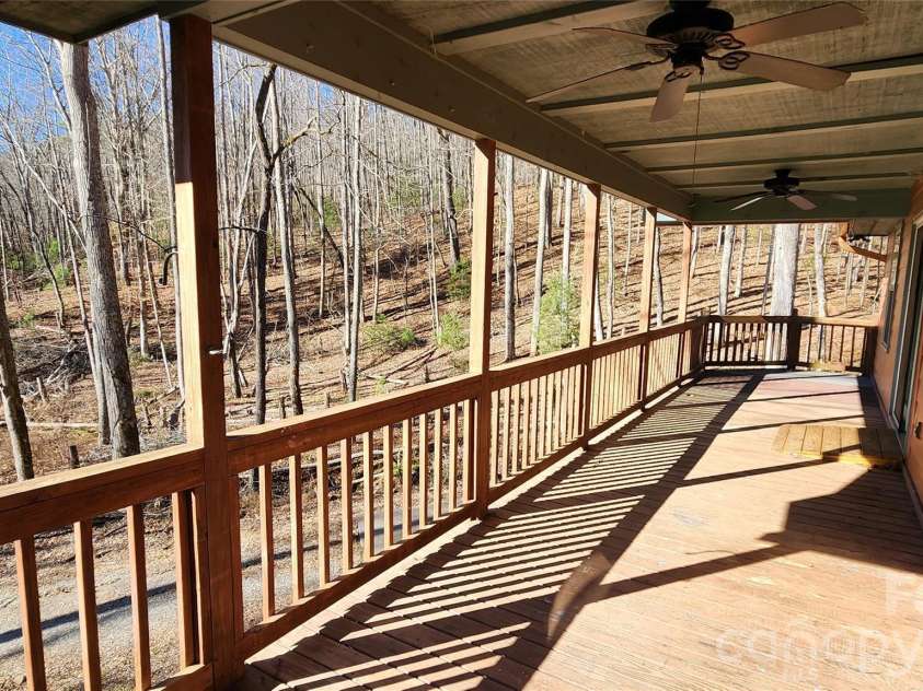 115 Old Camptown Drive, Hayesville, NC 28904.  MLS# CAR4337548, YatesRealty ID 8218. Big covered front porch overlooks woods
