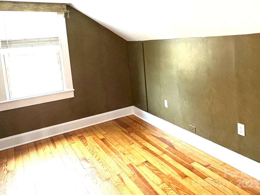 114 Broadway Avenue, Tryon, NC 28782.  MLS# CAR4322856, YatesRealty ID 823. Bedroom number 3 is nestled under the eaves.