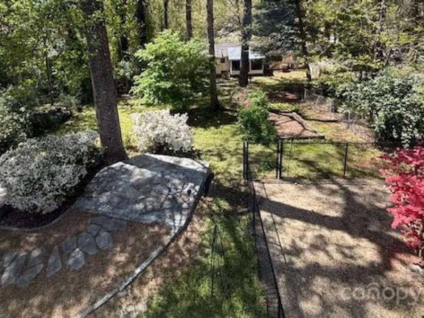 114 Broadway Avenue, Tryon, NC 28782.  MLS# CAR4322856, YatesRealty ID 823. Birds Eye view of the back yard, fenced dog pen on the right and flagstone terraces on the left! One of the terraces is designed for a hot tub.