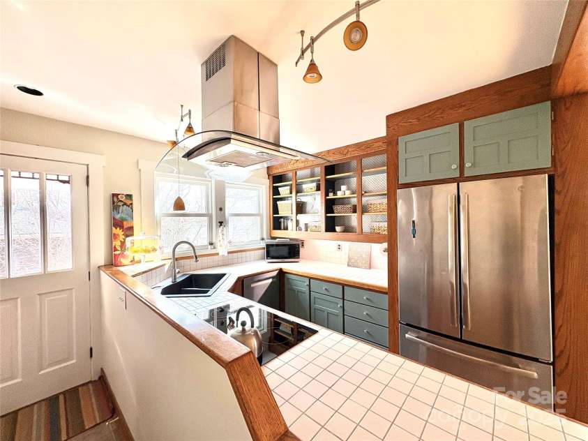 114 Broadway Avenue, Tryon, NC 28782.  MLS# CAR4322856, YatesRealty ID 823. Custom kitchen with an induction cooktop, convection oven, dishwasher and refrigerator. 