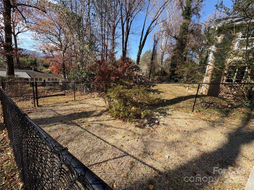 114 Broadway Avenue, Tryon, NC 28782.  MLS# CAR4322856, YatesRealty ID 823. Fully fenced dog yard with direct access from the house. Safe and convenient!