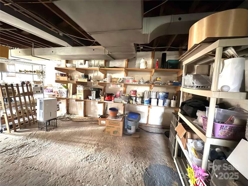 114 Broadway Avenue, Tryon, NC 28782.  MLS# CAR4322856, YatesRealty ID 823. Huge walkout basement with windows and tons of storage space.