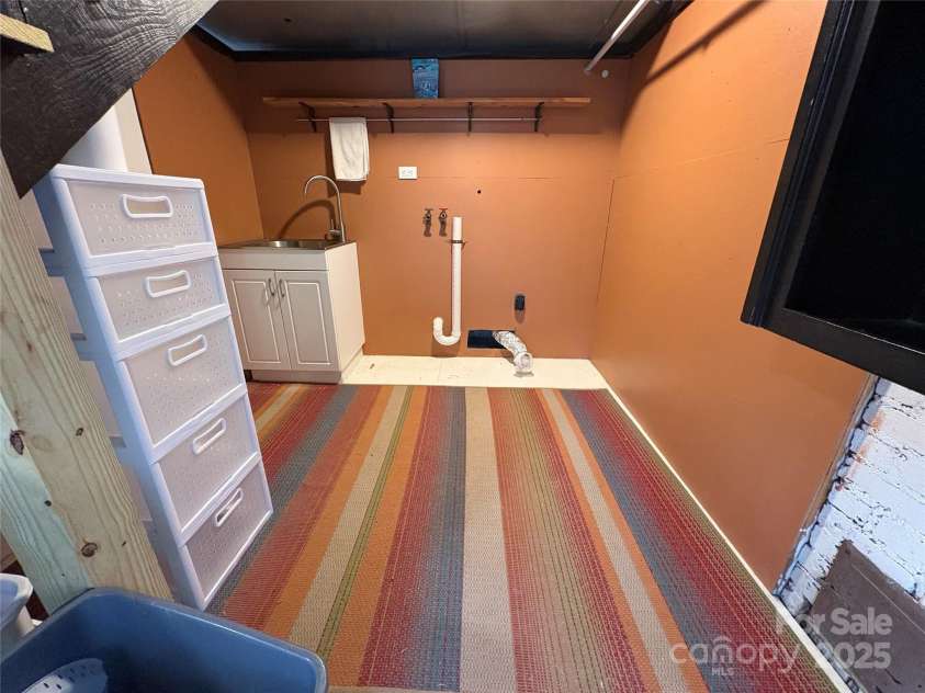 114 Broadway Avenue, Tryon, NC 28782.  MLS# CAR4322856, YatesRealty ID 823. Laundry area in the basement with sink. There is also a perfect location for a washer dryer on the main level.