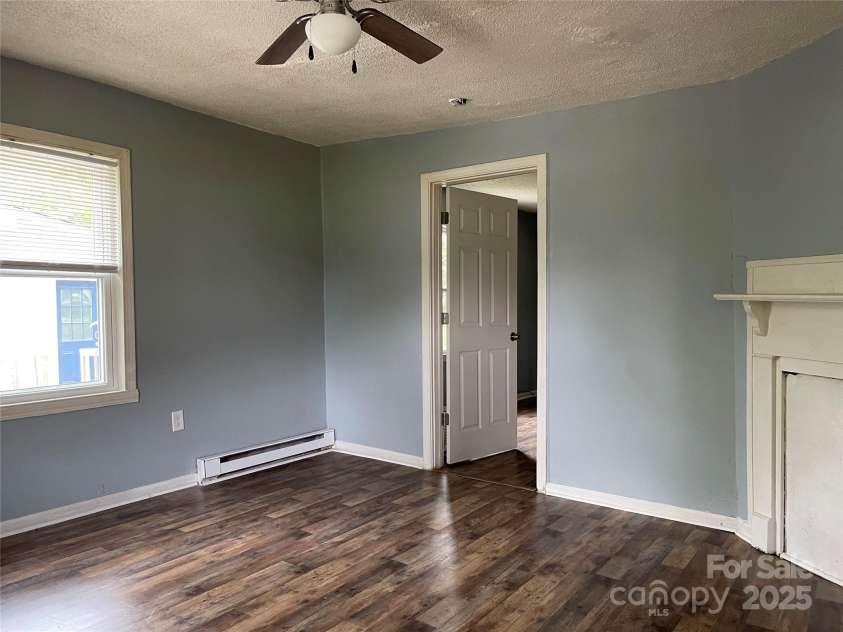 215 Mahan Street, Concord, NC 28025.  MLS# CAR4250870, YatesRealty ID 8242. Family room on Left side