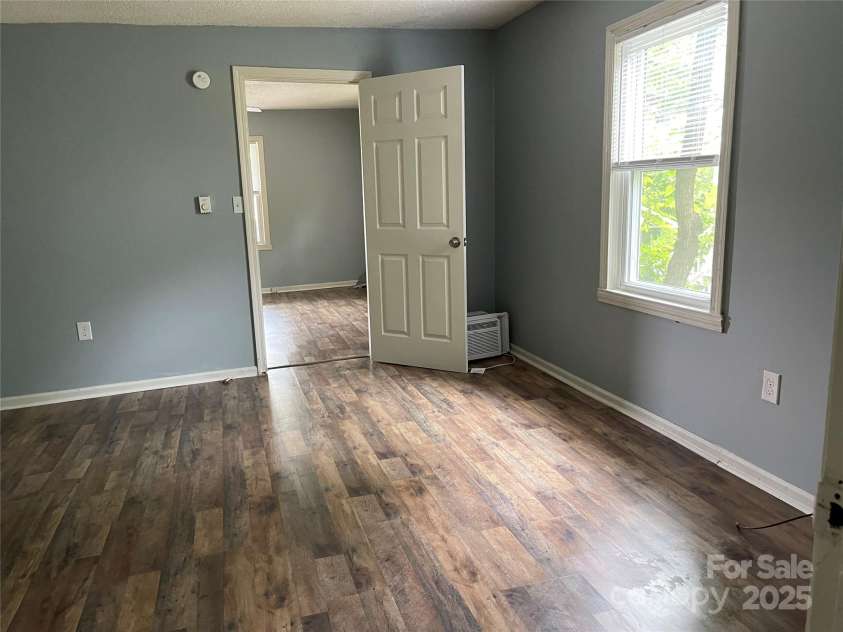 215 Mahan Street, Concord, NC 28025.  MLS# CAR4250870, YatesRealty ID 8242. Family room on right side