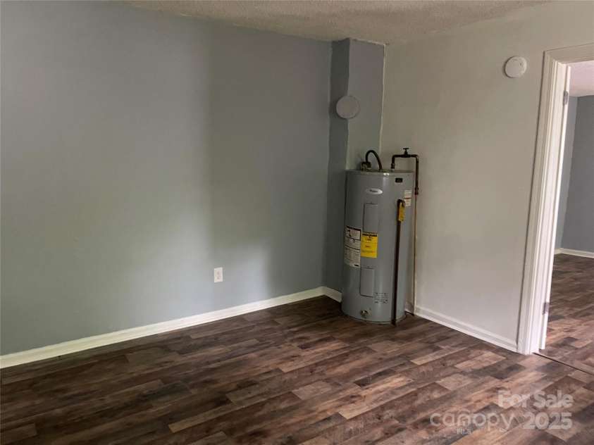 215 Mahan Street, Concord, NC 28025.  MLS# CAR4250870, YatesRealty ID 8242. Kitchen area on left side with eat in area