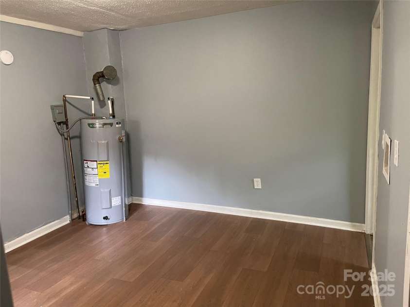 215 Mahan Street, Concord, NC 28025.  MLS# CAR4250870, YatesRealty ID 8242. Kitchen on right side with eat in area