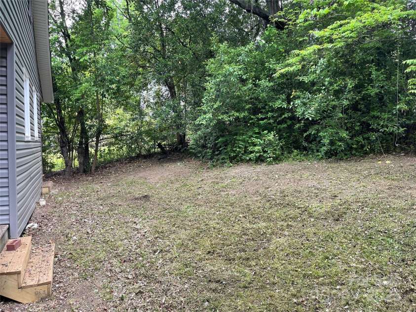 215 Mahan Street, Concord, NC 28025.  MLS# CAR4250870, YatesRealty ID 8242. Private shared back yard