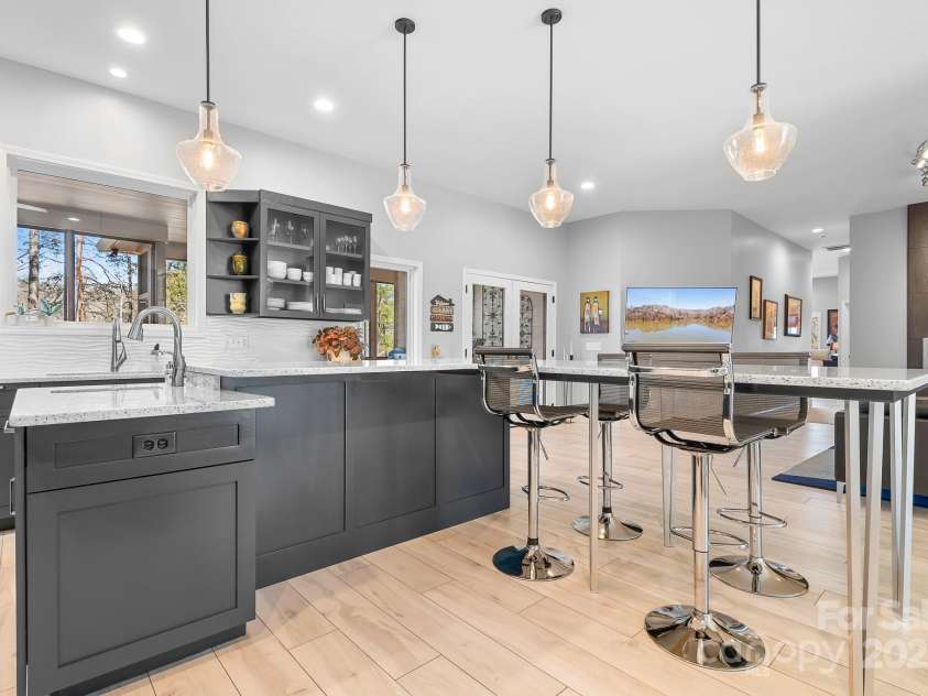 940 Hawk Ridge Drive, Mill Spring, NC 28756.  MLS# CAR4227450, YatesRealty ID 8244. Kitchen Island with prep-sink, pendant lights and modern touches.