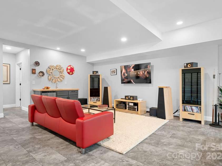 940 Hawk Ridge Drive, Mill Spring, NC 28756.  MLS# CAR4227450, YatesRealty ID 8244. Lower level/basement finished space with tons of options for entertainment, gym, office space etc.