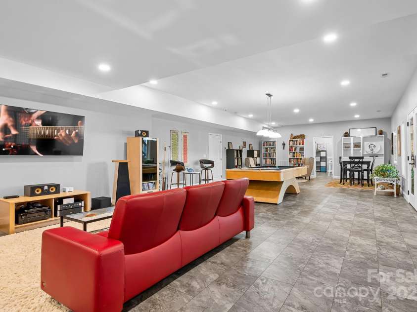 940 Hawk Ridge Drive, Mill Spring, NC 28756.  MLS# CAR4227450, YatesRealty ID 8244. Lower level/basement finished space with tons of options for entertainment, gym, office space etc.