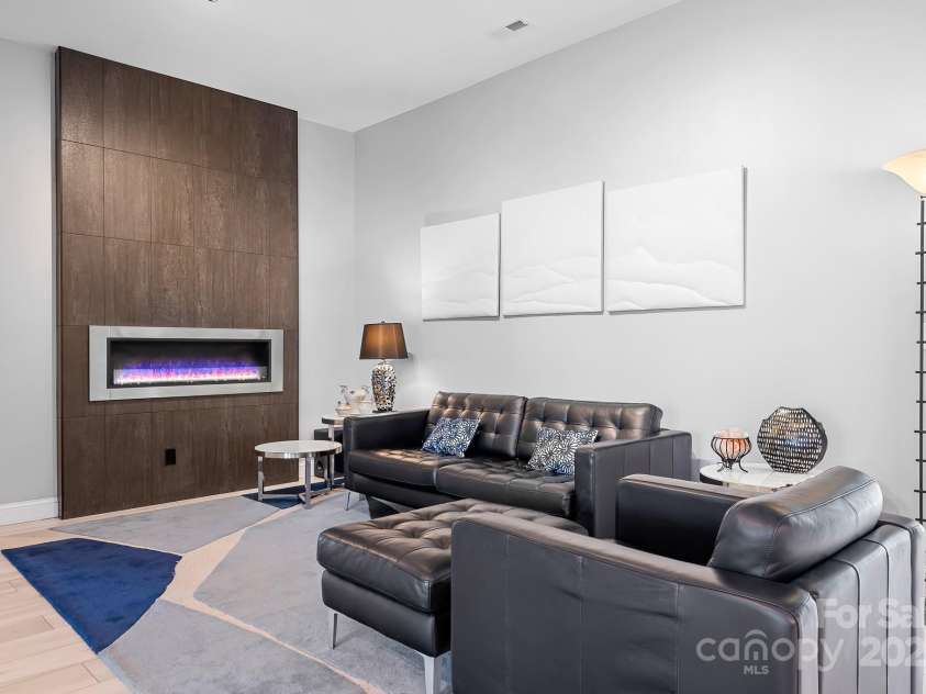 940 Hawk Ridge Drive, Mill Spring, NC 28756.  MLS# CAR4227450, YatesRealty ID 8244. Modern Family Room with custom ethanol fireplace and surround.