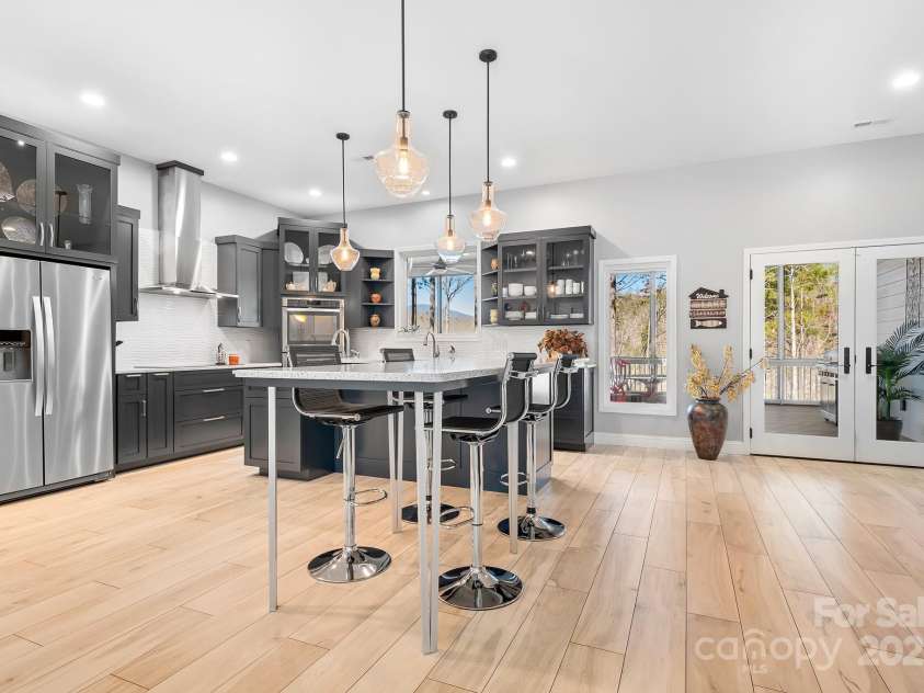 940 Hawk Ridge Drive, Mill Spring, NC 28756.  MLS# CAR4227450, YatesRealty ID 8244. Modern interior with gourmet kitchens and spa like living spaces! Kitchen Island, Pendant Lighting, Induction Cooktop and top of the line appliances!