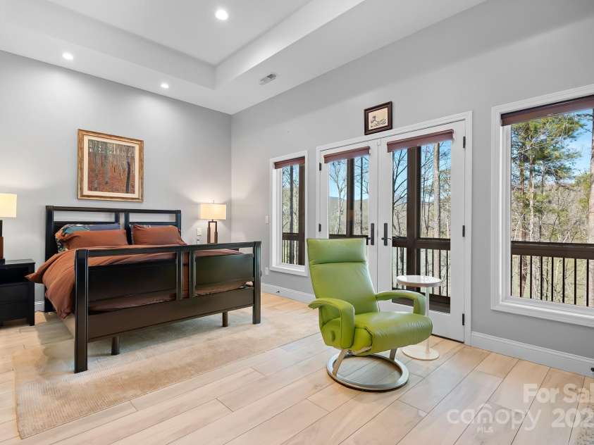 940 Hawk Ridge Drive, Mill Spring, NC 28756.  MLS# CAR4227450, YatesRealty ID 8244. Second Primary Suite with Primary Suite with Tray Ceilings, French Doors to screened porch and spa bathroom
