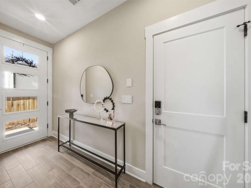 1602 Julia Maulden Place, Charlotte, NC 28206.  MLS# CAR4356693, YatesRealty ID 8256. Foyer and garage door
