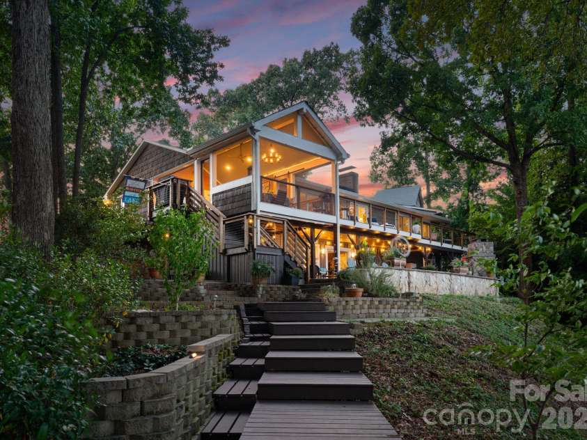 16318 Belle Isle Drive, Cornelius, NC 28031.  MLS# CAR4292940, YatesRealty ID 8272. Enveloped in mature gardens and trees for ultimate privacy.