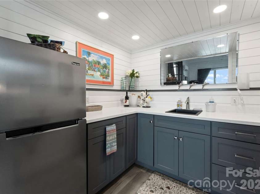 16318 Belle Isle Drive, Cornelius, NC 28031.  MLS# CAR4292940, YatesRealty ID 8272. Kitchen with sink, refrigerator and cabinetry