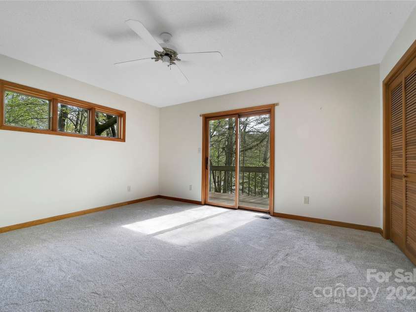 228 Echota Lane, Brevard, NC 28712.  MLS# CAR4249014, YatesRealty ID 8276. Primary bedroom opens up to deck over looking lake