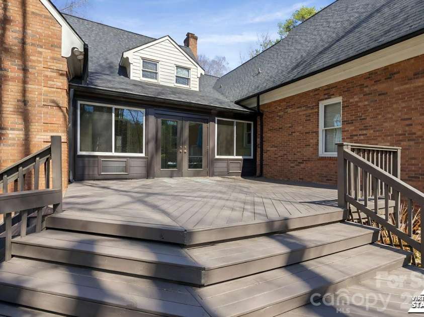 25 Blenheim Court, Concord, NC 28025.  MLS# CAR4347526, YatesRealty ID 8284. Sunroom leads out to bi-level deck