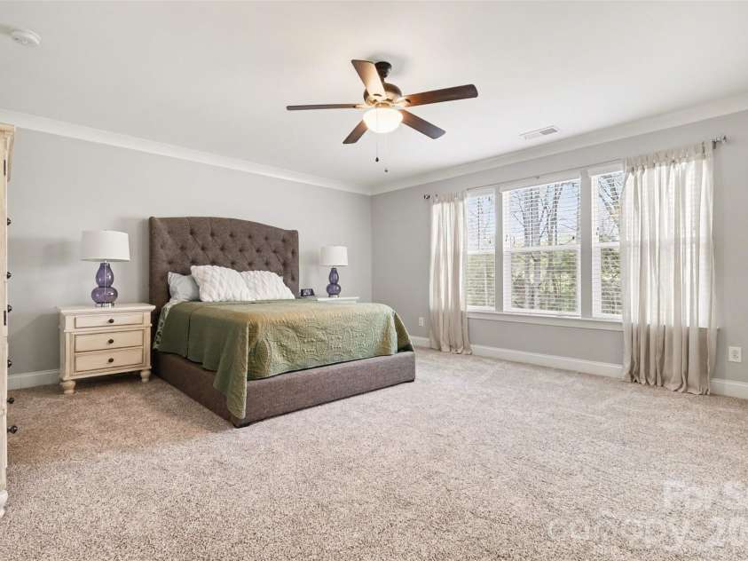 174 Country Lake Drive, Mooresville, NC 28115.  MLS# CAR4361802, YatesRealty ID 8293. Large primary bedroom upstairs, overlooks the private back yard.