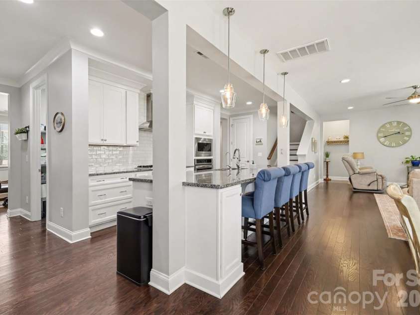 174 Country Lake Drive, Mooresville, NC 28115.  MLS# CAR4361802, YatesRealty ID 8293. More seating options. Gas stove and lovely hood for a chefs dream kitchen. Huge pantry as well.