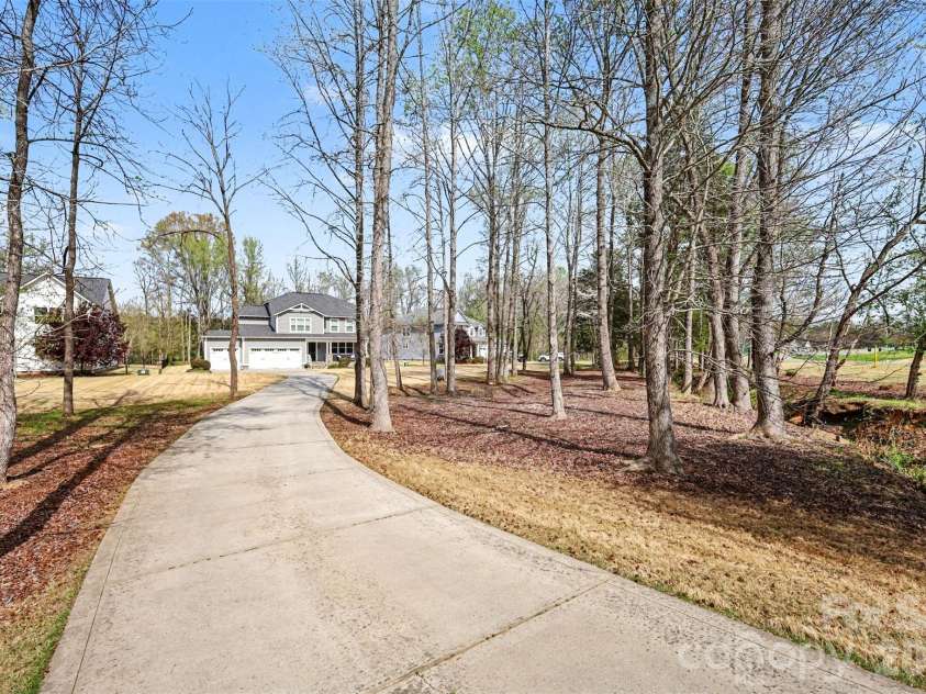 174 Country Lake Drive, Mooresville, NC 28115.  MLS# CAR4361802, YatesRealty ID 8293. Southern charm with this long drive to your next home!