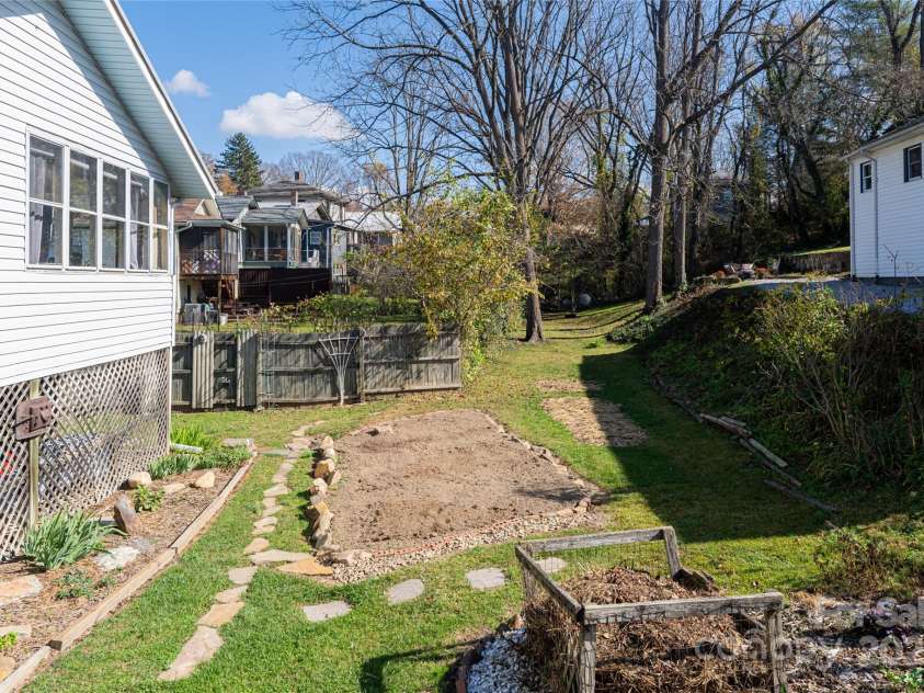 89 Woodrow Avenue, Asheville, NC 28801.  MLS# CAR4186528, YatesRealty ID 8319. Raised garden beds await your next planting. Selles installed french drain system.