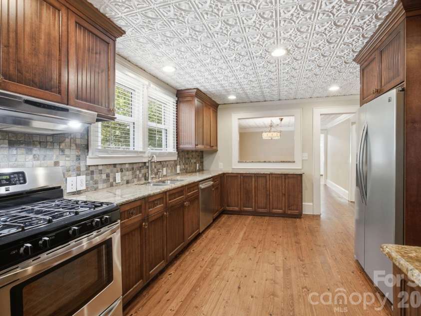 19428 Zion Avenue, Cornelius, NC 28031.  MLS# CAR4314350, YatesRealty ID 8324. Gas range and pass-thru to Dining Room