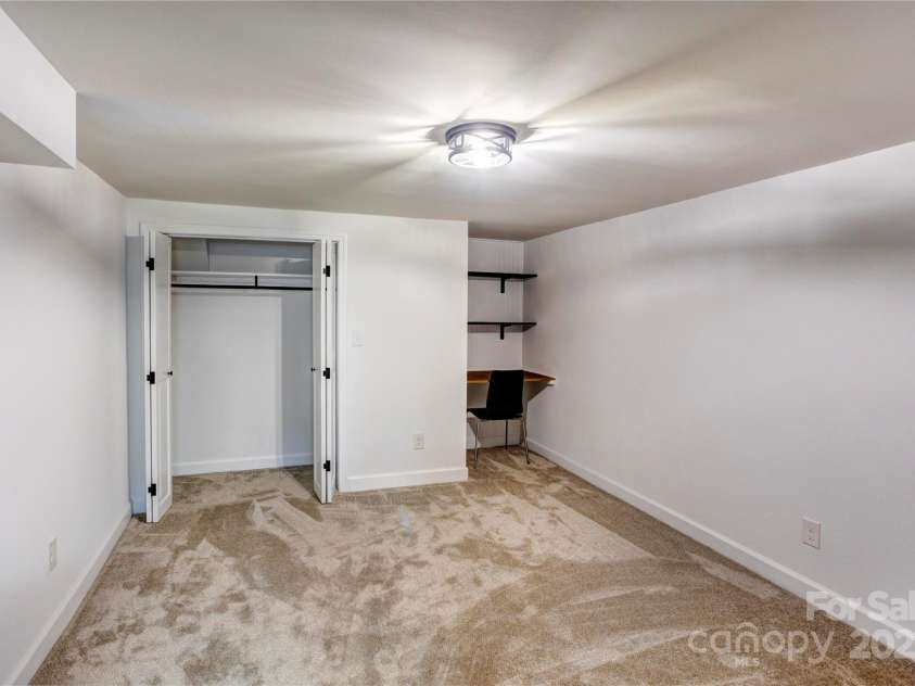 308 Dakota Street, Kannapolis, NC 28083.  MLS# CAR4227333, YatesRealty ID 8330. Basement room that can be used as bedroom with built in desk and closet.