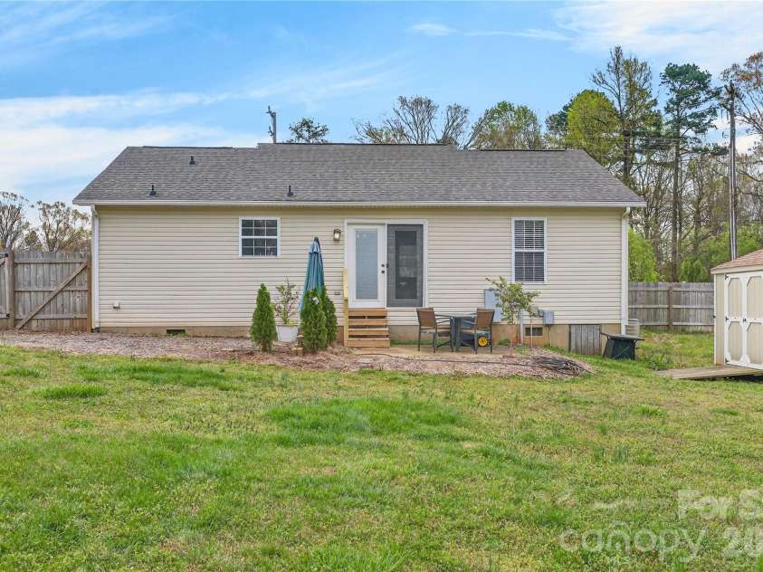 130 State Park Road, Troutman, NC 28166.  MLS# CAR4362515, YatesRealty ID 8341. Expansive, fully fenced backyard complete with a utility building, providing ample storage and versality. 