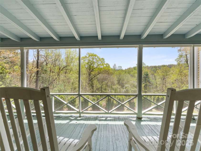 443 Shand Street, Saluda, NC 28773.  MLS# CAR4247244, YatesRealty ID 8346. Screened porch looking out the back of the property
