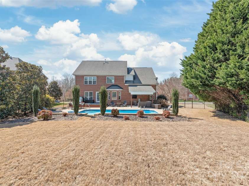 5608 Old Town Lane, Gastonia, NC 28056.  MLS# CAR4232073, YatesRealty ID 8361. Backyard beyond the pool