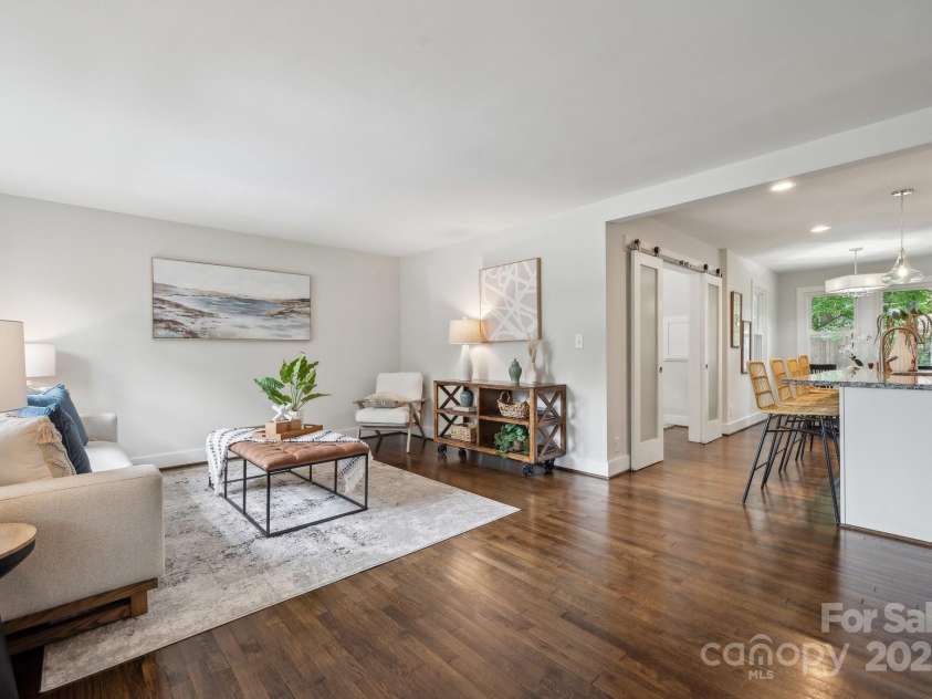3725 Dunwoody Drive, Charlotte, NC 28215.  MLS# CAR4245588, YatesRealty ID 8389. Living room leading into the bright, updated kitchen complete with a bar area, granite countertops, and SS appliances.