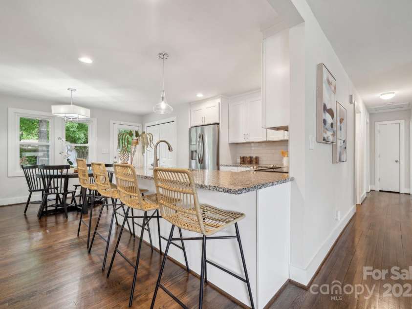 3725 Dunwoody Drive, Charlotte, NC 28215.  MLS# CAR4245588, YatesRealty ID 8389. The bright, updated kitchen comes complete with a bar area, granite countertops, and SS appliances.