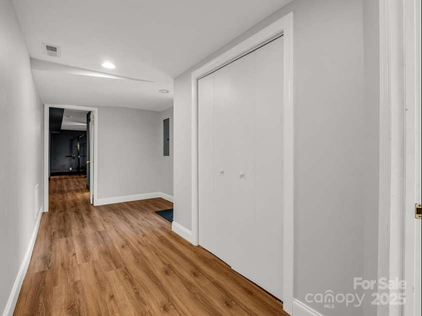 2115 Stoney View Court, Hendersonville, NC 28792.  MLS# CAR4310001, YatesRealty ID 839. Beautifully finished lower level featuring luxury vinyl flooring, fresh paint, and ample closet space — perfect for recreation, a home gym, or additional living area