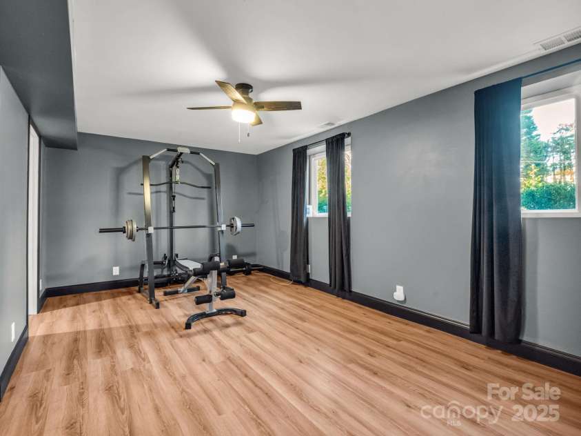 2115 Stoney View Court, Hendersonville, NC 28792.  MLS# CAR4310001, YatesRealty ID 839. Beautifully finished lower level featuring luxury vinyl flooring, fresh paint, and ample closet space — perfect for recreation, a home gym, or additional living area
