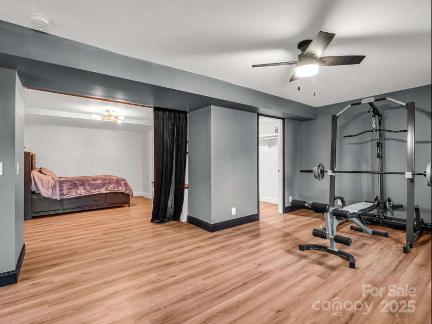 2115 Stoney View Court, Hendersonville, NC 28792.  MLS# CAR4310001, YatesRealty ID 839. Beautifully finished lower level featuring luxury vinyl flooring, fresh paint, and ample closet space — perfect for recreation, a home gym, or additional living area