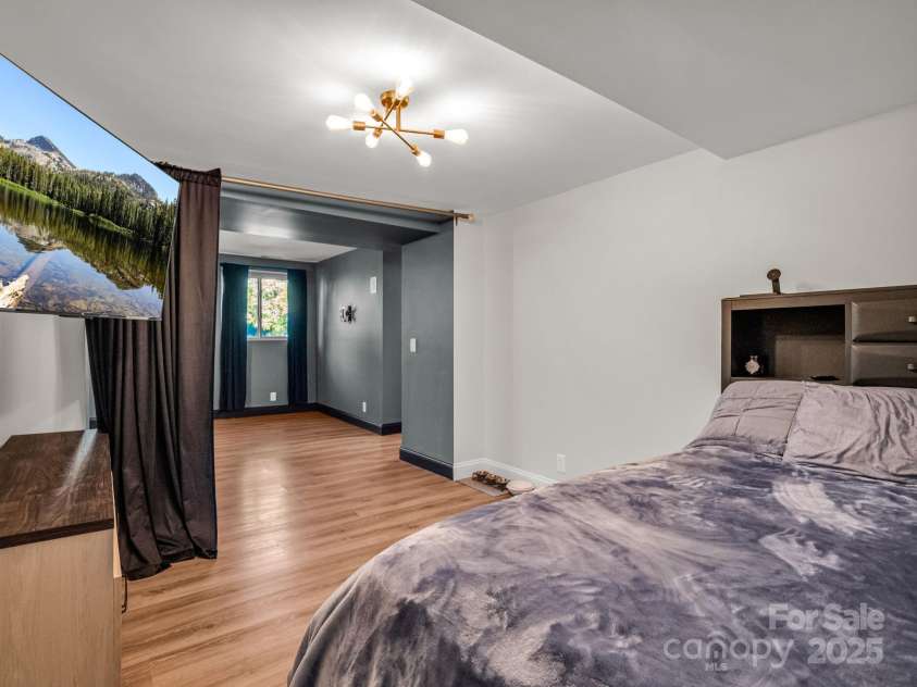 2115 Stoney View Court, Hendersonville, NC 28792.  MLS# CAR4310001, YatesRealty ID 839. Beautifully finished lower level featuring luxury vinyl flooring, fresh paint, and ample closet space — perfect for recreation, a home gym, or additional living area