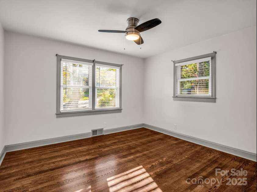 2115 Stoney View Court, Hendersonville, NC 28792.  MLS# CAR4310001, YatesRealty ID 839. Beautifully updated guest bedrooms with timeless hardwood floors, ample natural light, and a neutral design